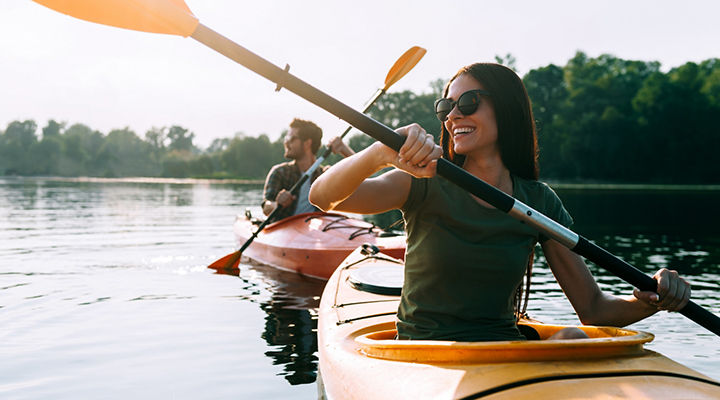 a woman and a man out kayaking having a great time